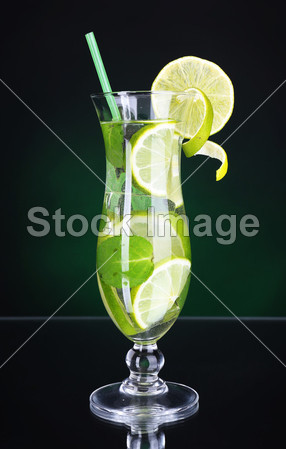 e and mint on table on dark green background图