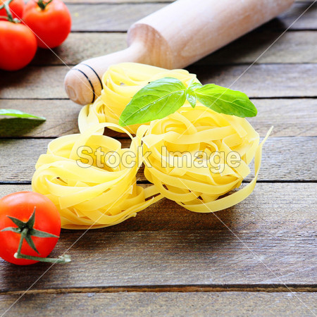 Pasta and rolling pin on the wooden backgroun