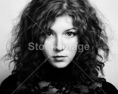 卷曲的头发的年轻美丽女子的画像。复古的肖像