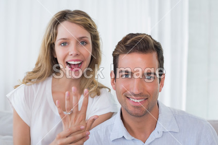 Woman showing engagement ring besides ma