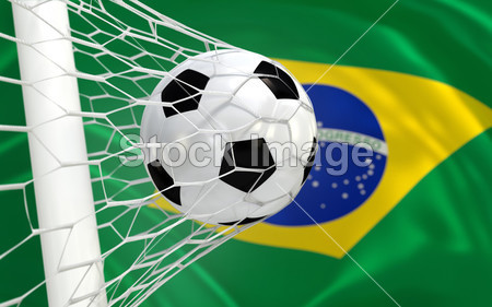 Brazil waving flag and soccer ball in goal net图片