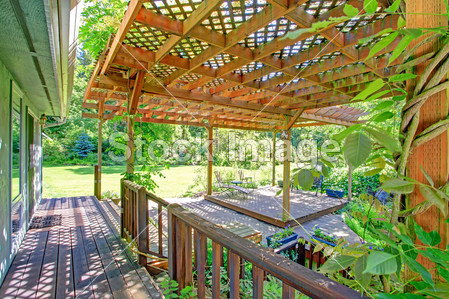 Backyard farm deck with attached open pergol