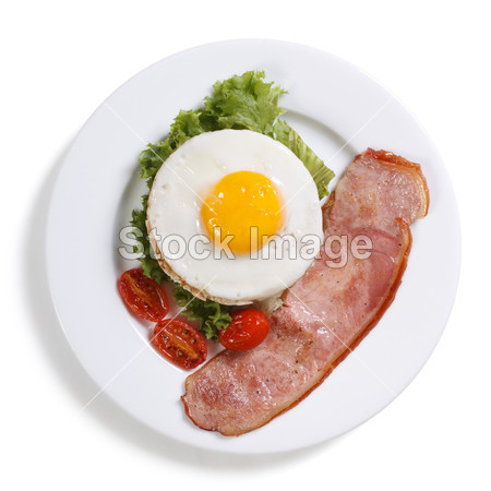 Fried eggs with vegetables and ham isolated. t