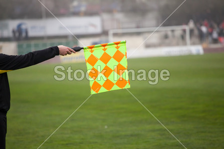 Soccer referee hold the flag. Offside trap图片素