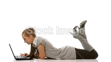Lying teenager girl with laptop (isolated)图片素