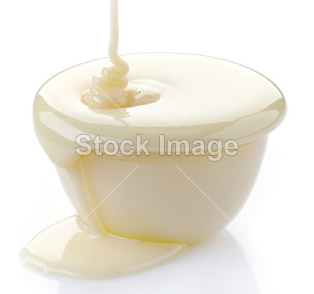 Pouring condensed milk with sugar in a bowl图