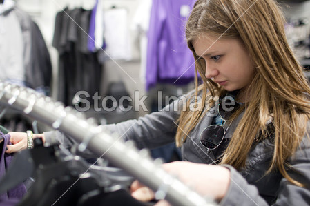 Pretty teenager shopping for clothes in a boutiq