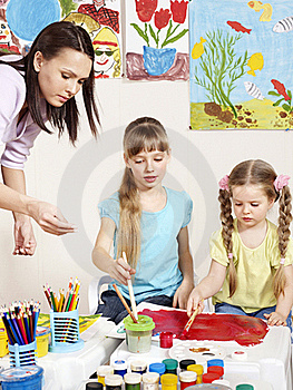 children painting in art class at elementary school